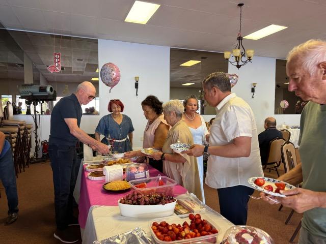 fernandez-with-residents-serving-food.jpeg
