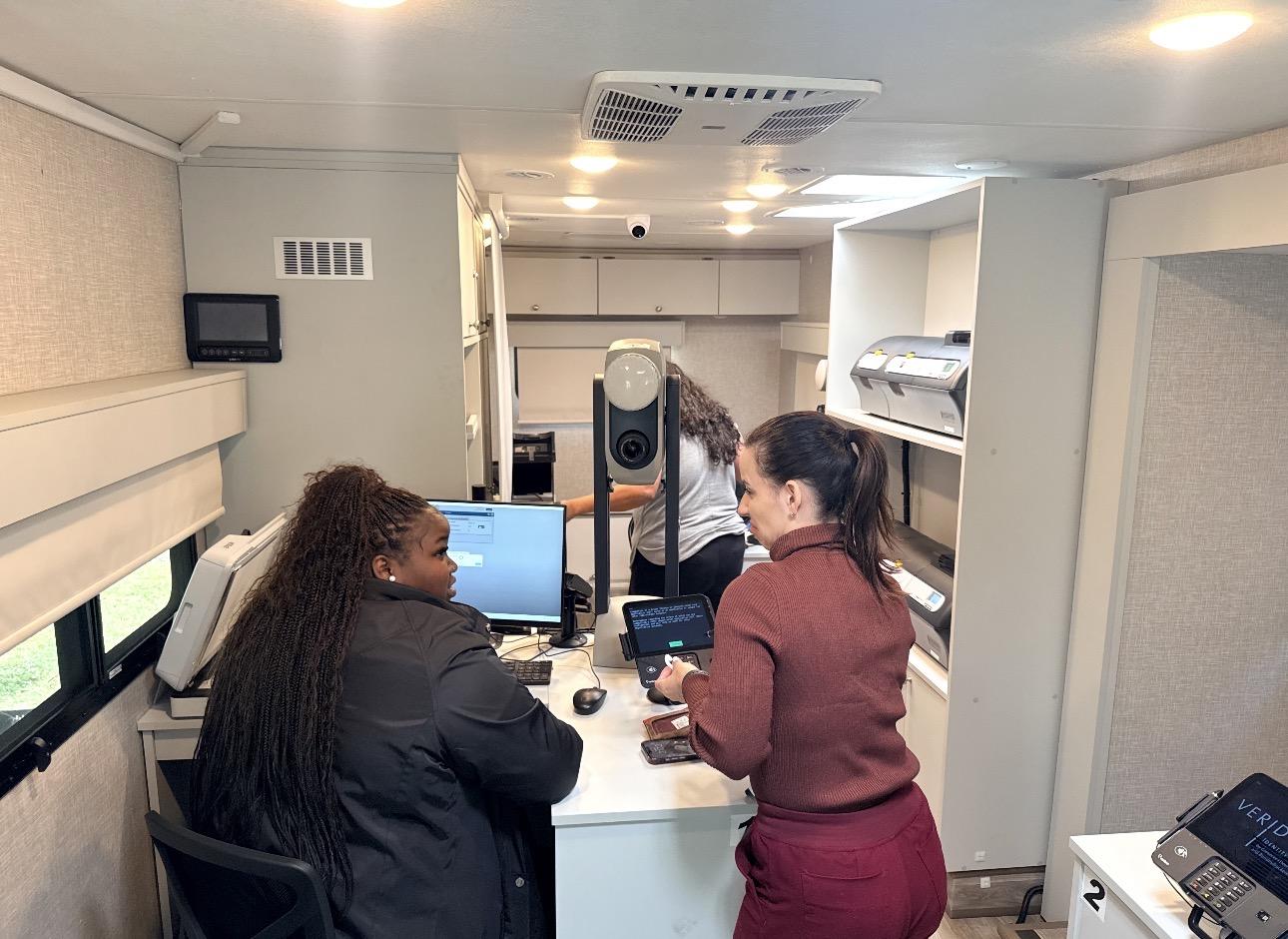 Tax Collector Staff Assisting Resident inside the Bus